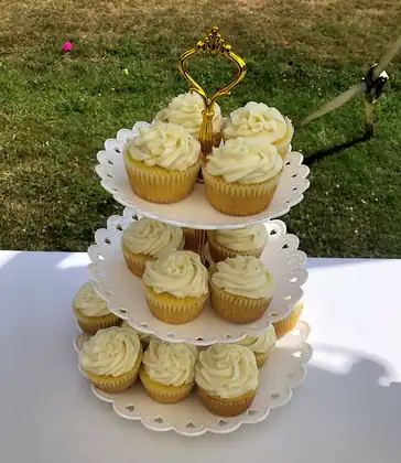 Three-tier stand of buttercream cupcakes