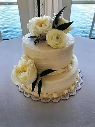Traditional white wedding cake with fresh white flowers