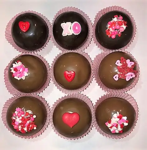 Hot chocolate bombs decorated with hearts and sprinkles