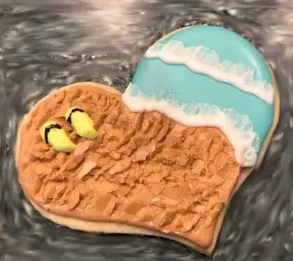 Heart shaped sugar cookie with sand and ocean design